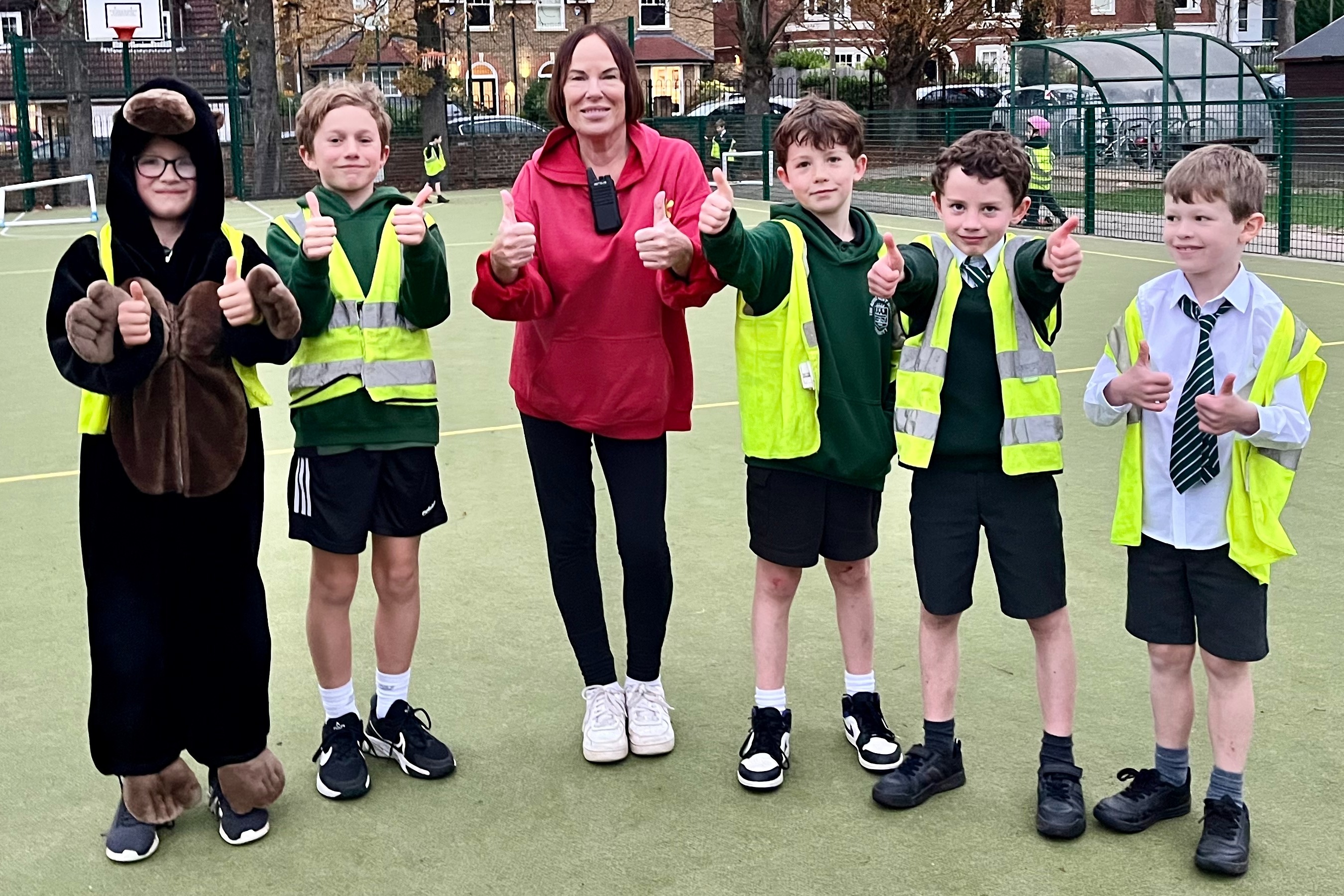 Clubland staff and children giving a thumbs up