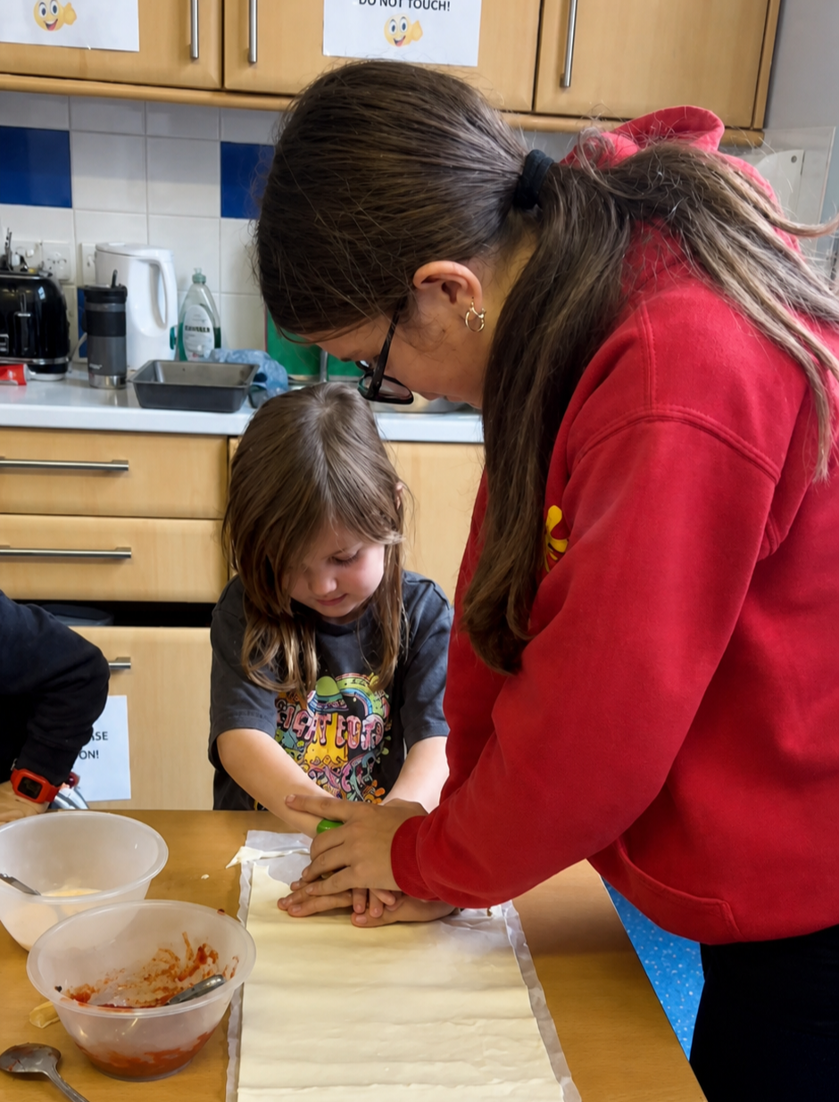Support Worker helping a child with a cookery activity